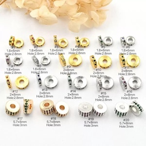 May include: Assortment of small, decorative beads in gold and silver tones, with various colored gemstones. The beads are round and cylindrical, with different sizes and hole diameters. Ideal for jewelry making and crafts.
