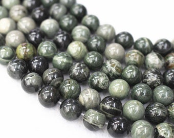 May include: A strand of round, green and black gemstone beads. The beads have a marbled pattern and are polished.