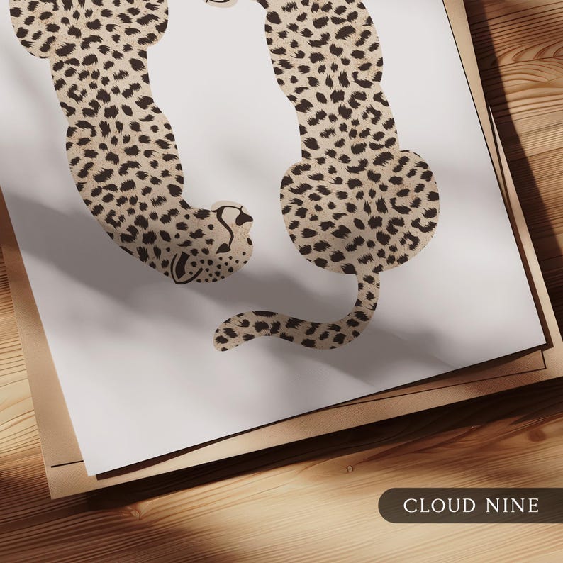 May include: Two brown and black cheetah print silhouettes on a white background. The cheetahs are facing opposite directions, with one cheetah curled up and the other standing upright. The text "CLOUD NINE" is printed in black at the bottom of the image.