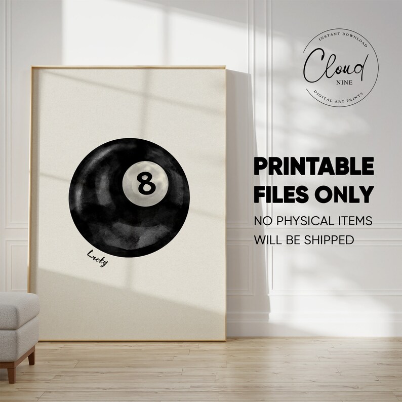 May include: A black and white watercolour illustration of a pool ball with the number 8 on it. The ball is surrounded by a black watercolour wash and the word "Lucky" is written below it.