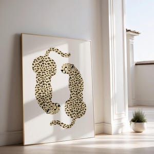 May include: A framed print of two cheetahs in a stylized design. The cheetahs are facing each other, with their bodies forming a circle. The background is white.