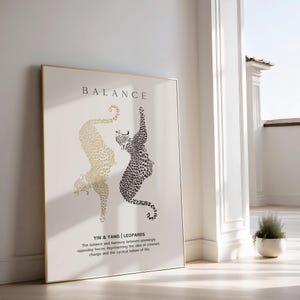 Peut inclure: Une impression encadr&eacute;e en noir et or avec le mot "BALANCE" en grandes lettres en haut. L'impression pr&eacute;sente deux l&eacute;opards stylis&eacute;s, l'un noir et l'autre or, se faisant face dans un design yin et yang. Le texte sous les l&eacute;opards se lit comme suit : "YIN & YANG | LEOPARDS L'&eacute;quilibre et l'harmonie entre des forces apparemment oppos&eacute;es. Repr&eacute;sentant l'id&eacute;e de changement constant et la nature cyclique de la vie."