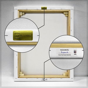 May include: The back of a stretched canvas painting with a wooden frame. The canvas is white and has a gold label that says "Handcrafted By: Eugene K. From The Finest Materials" and a small American flag.