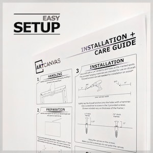 May include: A black and white illustration showing how to hang a canvas on a wall. The instructions include using a drill bit, drywall anchors, and screws. The image also shows the different sizes of screws needed for different thicknesses of frames.