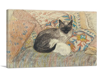 May include: A black and white Siamese cat is sleeping on a bed of colorful patterned pillows. The cat is curled up with its tail tucked under its body. The pillows are a mix of red, blue, yellow, and white.
