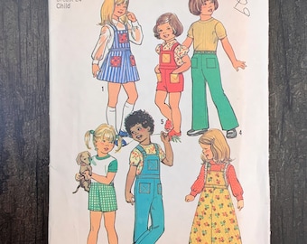 May include: Simplicity sewing pattern number 6781 for children's clothing. The pattern includes five different designs for girls' dresses, overalls, and shirts. The pattern is for sizes 5, with a 24-inch chest.