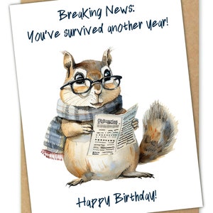 May include: A birthday card featuring a cartoon squirrel wearing glasses and a scarf, reading a newspaper with the headline "Obituaries". The card reads "Breaking News: You've survived another year! Happy Birthday!"