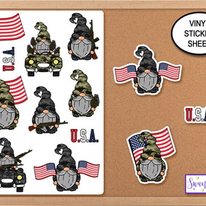 May include: A sheet of vinyl stickers featuring gnomes in various patriotic poses. The gnomes are wearing camouflage and holding American flags, guns, and driving a jeep. The text "U.S.A." and "VINYL STICKER SHEET" are also included.