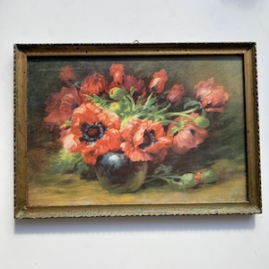 May include: A rectangular framed painting depicting a bouquet of vibrant red poppies in a dark, rounded vase. The flowers feature prominent black centers and green stems, set against a dark, moody background. The frame is a textured, metallic gold.
