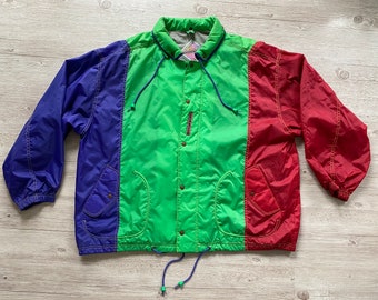 May include: A multi-colored jacket with a blue, green, and red color block design. The jacket has a drawstring hood, a button-up front, and two pockets on the front.