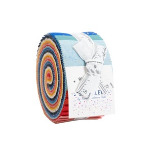May include: A rolled fabric bundle with a spiral pattern of red, orange, yellow, blue, and white. The bundle is tied with a white ribbon and a tag that reads "Riley Blake Designs" and "by Rachel coleman-Hale".