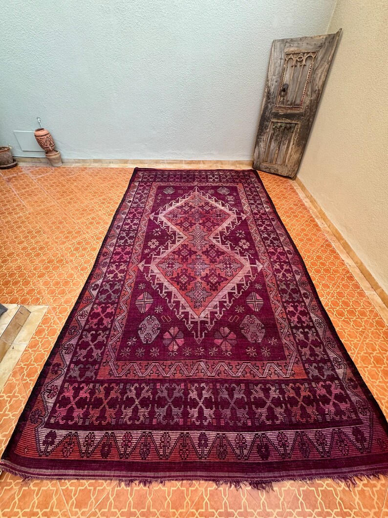 Turn the rug upside down at least once every three months, allowing foot traffic to assist in settling dust onto the floor, reminiscent of the traditional practice observed by Moroccan people.
