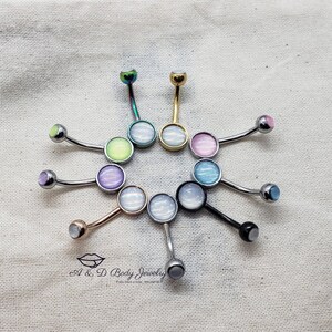 May include: A variety of belly button rings with different colored opal stones. The rings are made of surgical steel and have a curved barbell design.