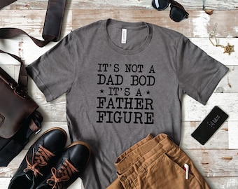 May include: A gray t-shirt with the text "It's not a Dad Bod * It's a Father Figure" printed in black.