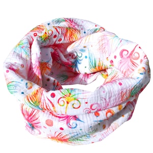 May include: White cotton scarf with a colorful feather print. The scarf is rolled up into a circle and has a white background with pink, blue, green, yellow, and orange feathers.