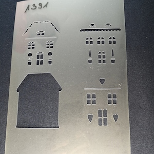 May include: A clear plastic stencil with the number "1331" printed in the top left corner. The stencil features multiple house designs with windows and doors.