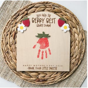 May include: A wooden sign with a handprint in the shape of a strawberry. The sign reads "You are the berry best hands down!" and "Happy Mother's Day 2024 -From, Your Little Sweetie".