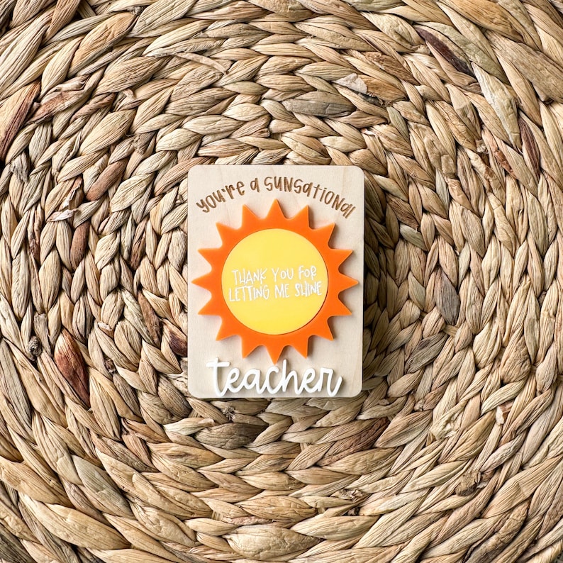 May include: A wooden sign with a sun graphic and the text "You're a sensational teacher. Thank you for letting me shine."