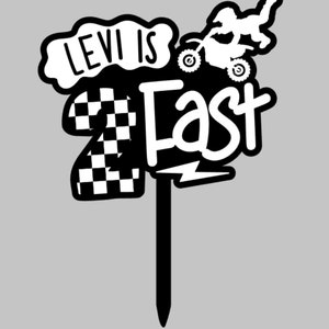 Layered acrylic 'Two Fast' second birthday cake topper with checkered flag pattern and dirt bike motif, on a gray background