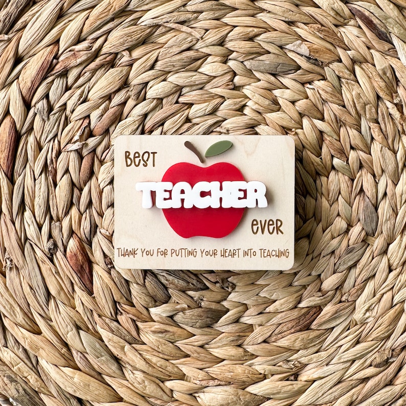 May include: Wooden sign with a red apple and the text "Best Teacher Ever" and "Thank you for putting your heart into teaching".
