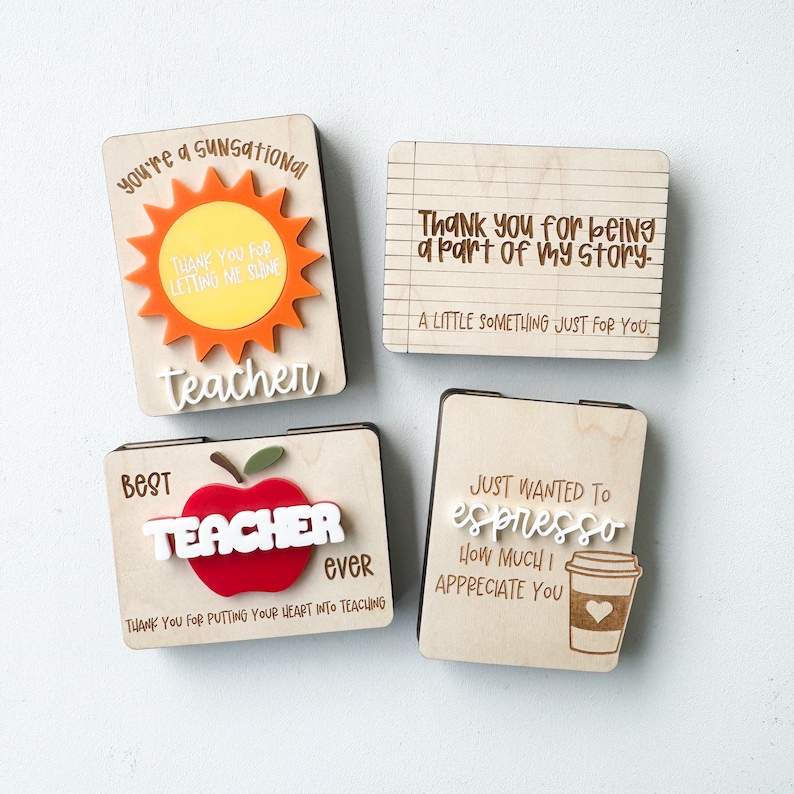 May include: Four wooden teacher appreciation signs with different designs. The first sign has a sun with the text "you're a sunsational teacher". The second sign has the text "Thank you for being a part of my story. A little something just for you". The third sign has an apple with the text "Best Teacher Ever" and the text "Thank you for putting your heart into teaching". The fourth sign has a coffee cup with the text "Just wanted to espresso how much I appreciate you".