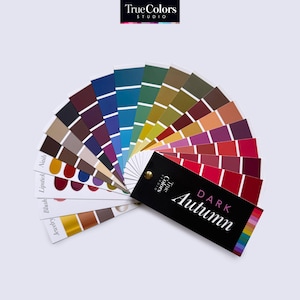 May include: A colour palette fan showing a range of colours for the Dark Autumn colour season. The fan is labelled "True Colors Studio" and "Dark Autumn".