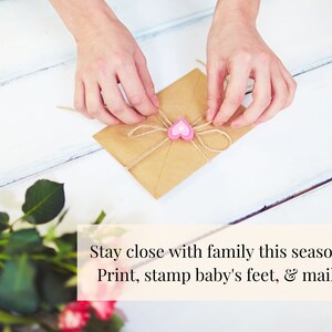 May include: A brown envelope tied with twine and a pink heart charm. The text "Stay close with family this season. Print, stamp baby's feet, & mail!" is written below the envelope.