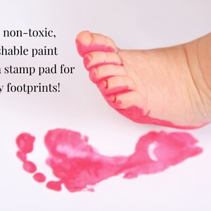 May include: A pink footprint on a white surface. The text "Use non-toxic, washable paint or a stamp pad for easy footprints!" is visible in the image.