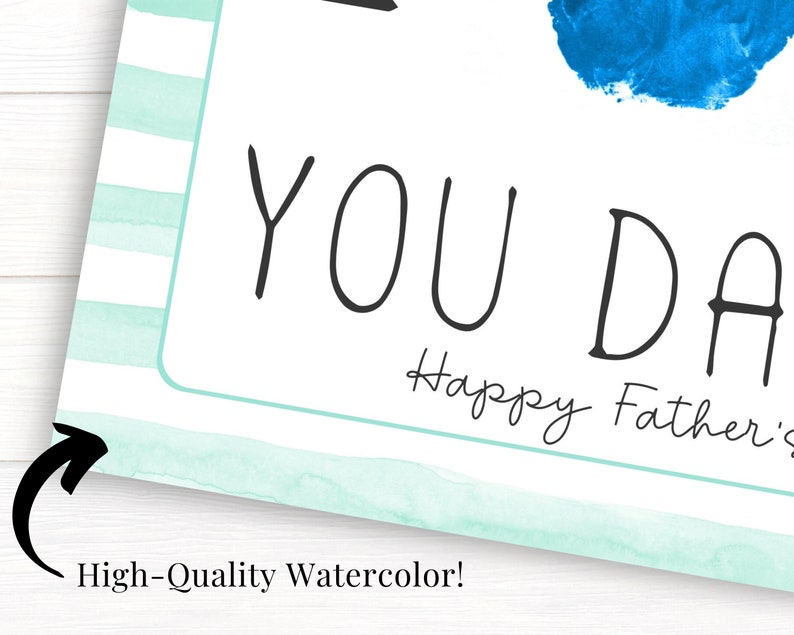 May include: A light blue and white striped card with the text "You Da" and "Happy Father's" in black cursive writing.