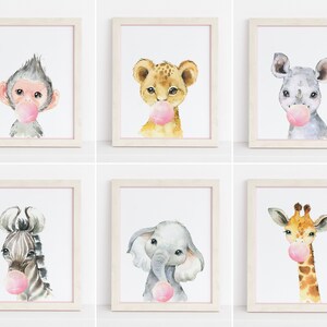 May include: Set of six watercolour animal prints featuring a monkey, lion, rhinoceros, zebra, elephant and giraffe, each with a pink bubble gum in their mouth.