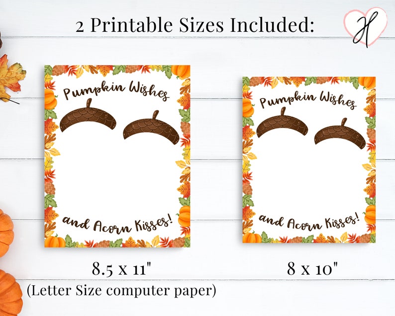 May include: Two printable cards with a fall theme. The cards feature a white background with a brown acorn border. The text on the cards reads "Pumpkin Wishes and Acorn Kisses!" The cards are available in two sizes: 8.5 x 11 inches and 8 x 10 inches.