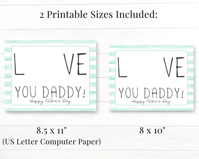 May include: Two printable Father's Day cards with a light blue and white striped background. The cards say "I Love You Daddy!" with the "O" in "Love" left blank for a photo. The cards are available in two sizes: 8.5 x 11 inches and 8 x 10 inches.