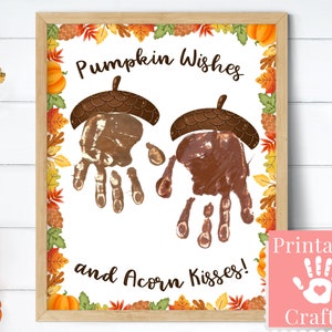 May include: Printable craft for kids featuring handprints in the shape of pumpkins and acorns. The text reads "Pumpkin Wishes and Acorn Kisses!" with a fall-themed border.