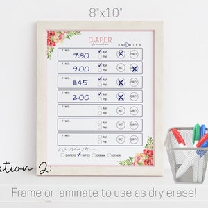 May include: A white 8x10 inch dry erase board with a floral border. The board is titled "Diaper Tracker" and has a checklist for tracking diaper changes, including time, AM/PM, wet, and dirty. The board is framed in a light wood frame.