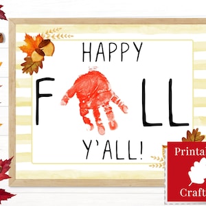 May include: Printable craft sign with the text "Happy Fall Y'all!" in black text. A red handprint is in the center of the sign. The sign has a yellow and white striped background with fall leaves and acorns in the top corner. The sign has a red border and a red "Printable Craft!" label with a white leaf in the bottom right corner.