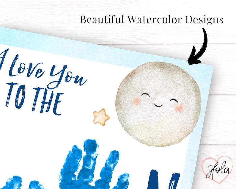 Beautiful closeup of the watercolor details on the I love you to the moon print. A smiling moon in the top right corner, light blue border with cute stars and hearts that surround the page. Handprints are stamped in place of the letter O in moon.