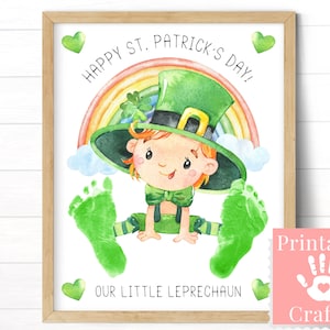 Framed 8x10 printable footprint craft that reads Happy Saint Patricks Day Our Little Leprechaun. A baby's footprints are stamped to look like the feet of a baby leprechaun.