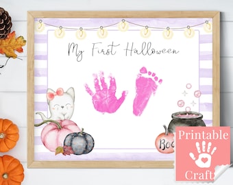 May include: A printable Halloween craft for a baby's first Halloween. The craft features a white cat with pink ears and a bow, a pumpkin, a cauldron, and a space for a baby's handprint and footprint. The text "My First Halloween" is at the top of the page.