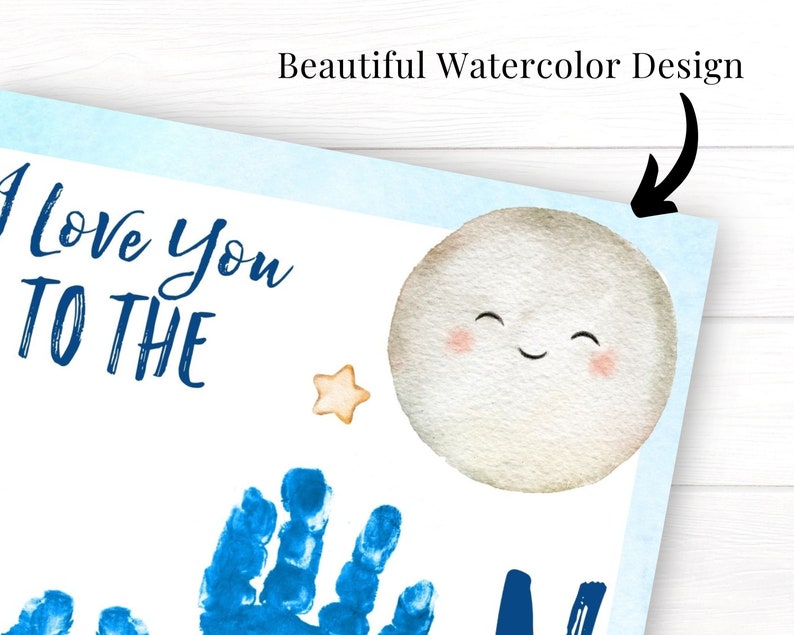May include: A white card with blue text that reads "I love you to the" and a blue handprint. A watercolor moon with a smiling face and a yellow star are also on the card.