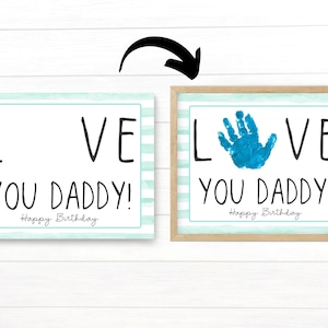 May include: Two printable cards with a blue and white striped background. The text on the cards reads "LOVE YOU DADDY! Happy Birthday". One card has a blank space for a handprint, and the other card has a blue handprint in the space.