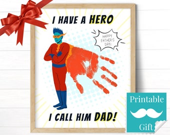 May include: Printable Father's Day card featuring a superhero illustration with a handprint. The text reads "I have a hero. Happy Father's Day! I call him Dad!"