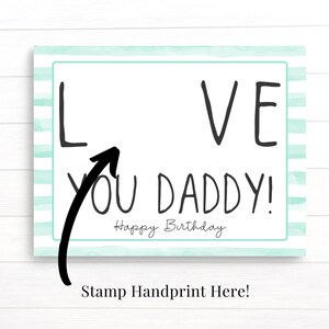 May include: A light blue and white striped card with the words "I LOVE YOU DADDY!" and "Happy Birthday" written in black. An arrow points to the "I" in "I LOVE YOU DADDY!" with the words "Stamp Handprint Here!" below the card.