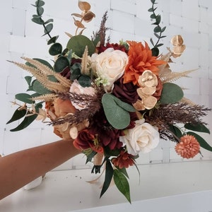 Rustic Autumn Fall Winter Wedding hand-tied bridal bouquet with burnt orange, creams, ivory ,gold and burgundy accents. Matching accessories