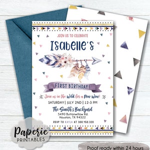 May include: A printable invitation for a first birthday party with a boho theme. The invitation features a watercolor arrow with feathers and flowers, and the text "Join us in the wild for a Pow Wow!"  The invitation is decorated with pink, blue, and gold triangles.