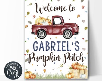 Könnte beinhalten: Ein Willkommenszeichen für einen Kürbis-Patch mit einem roten Pickup-Truck, der Kürbisse transportiert. Das Schild lautet "Willkommen auf Gabriels Kürbis-Patch".
