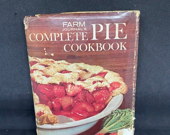 May include: A vintage cookbook titled "Farm Journal's Complete Pie Cookbook" with a red and white strawberry pie on the cover. The text "700 Best Dessert and Main-Dish Pies in the Country" is printed below the pie.