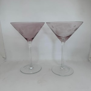 Pair of light purple martini glasses, clear stem, decorated with etched circles and stripes, holds 8 ounces, 7 inches tall, hand decorated