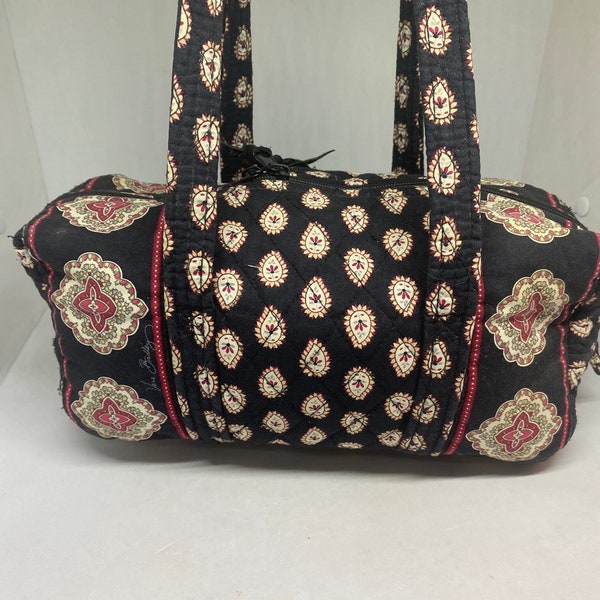 Vera Bradley retired pattern duffel shaped, medium sized shoulder bag in black with white and red designs, full top zip, inside pockets