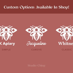 May include: A maroon background with white text and bee illustrations. The text reads "Custom Options Available In Shop!" and "LK Apiary", "Jacqueline", and "Whitney" with different font styles. The text "Studio Ching" is at the bottom.