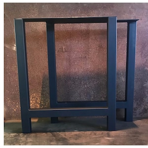 May include: Two dark blue metal table legs with a rectangular frame. The legs are made of sturdy metal and have a simple, modern design.